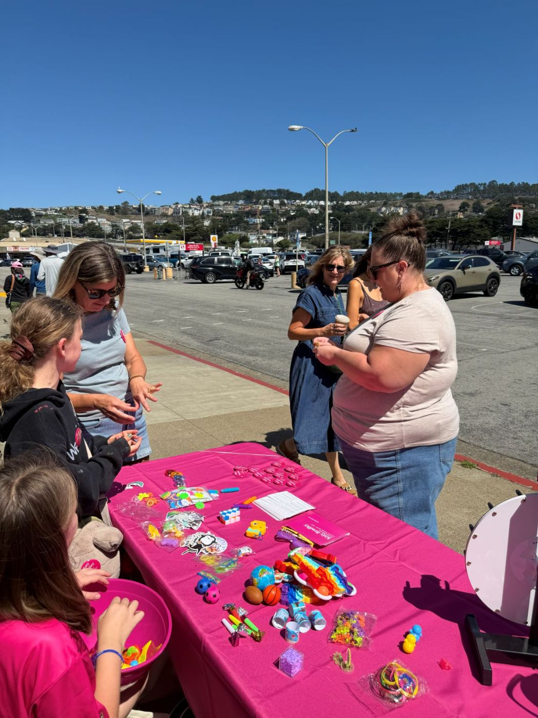 Katy Bradley talking with families at her campaign table outside Safeway